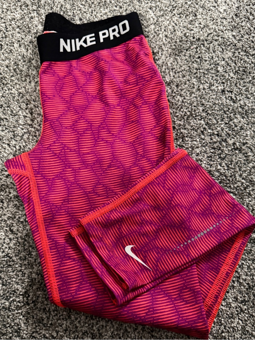 Nike Pro leggings with pink and orange geometric pattern, size M